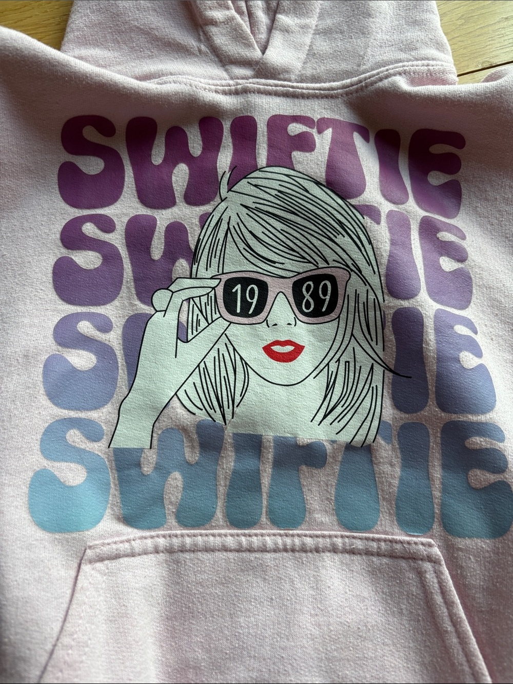 Gildan Light Pink "Swiftie" Graphic Hoodie with Purple & Blue Print
